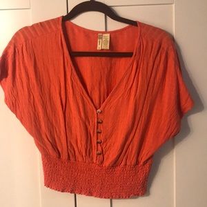 Woman’s orange top